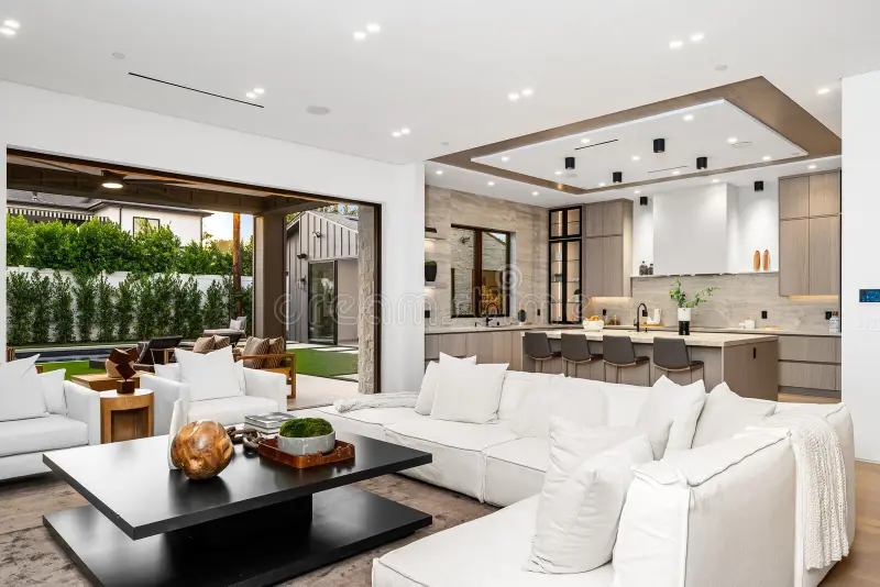 modern-open-plan-living-room-kitchen-white-sofas-sleek-design-outdoor-view-341130455